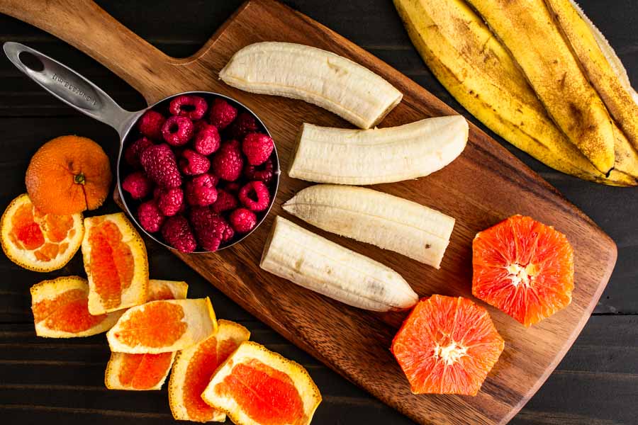 Fresh raspberries, bananas, and cara cara oranges