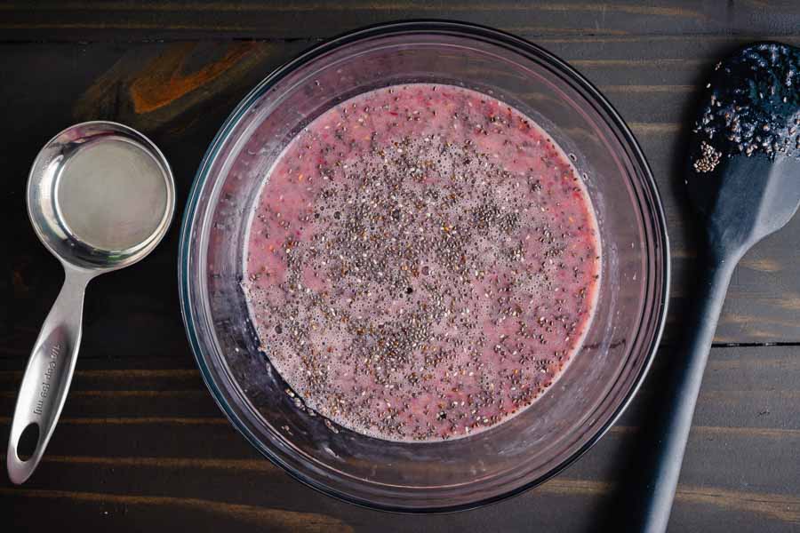 Chia seeds stirred into raspberry mixture