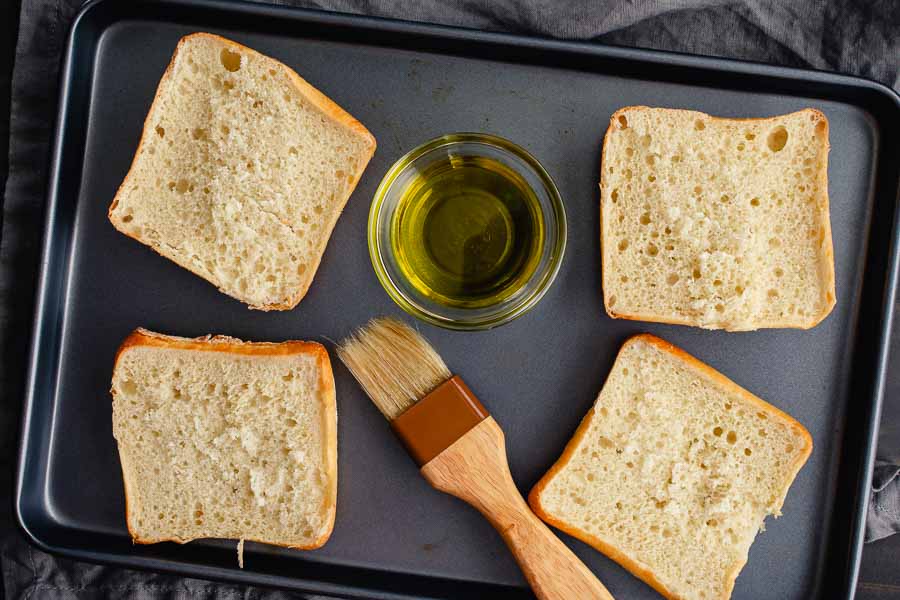 Lightly brush the bread with olive oil before toasting