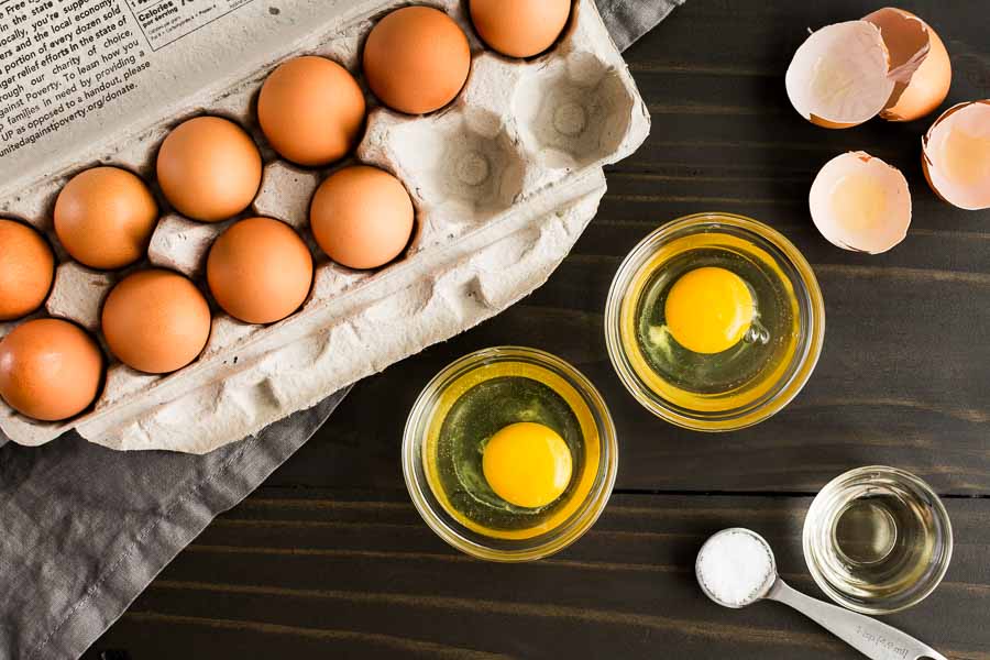 Crack the eggs into a small bowl and slip them into the water to poach