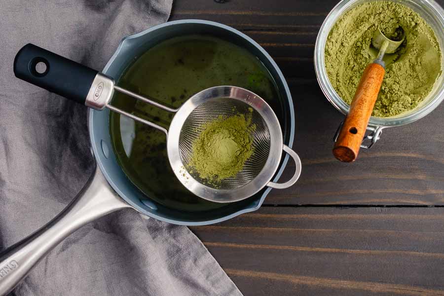 Sifting matcha into freshly made simple syrup