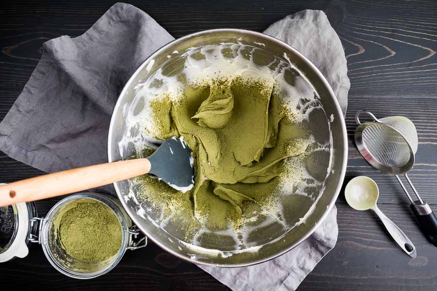 Matcha added to the beaten cream cheese-sugar mixture