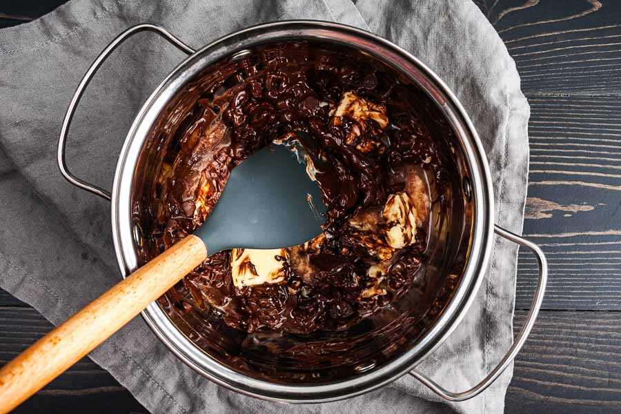 Mixing the melted butter with semi-sweet chocolate chips